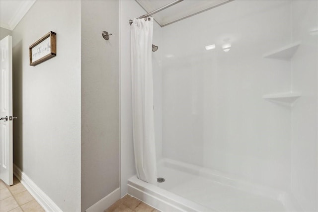 bathroom featuring tile patterned flooring, baseboards, and a shower stall