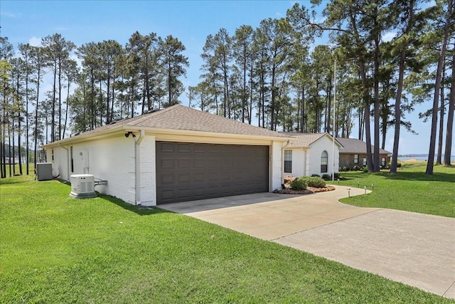 ranch-style home with brick siding, driveway, a garage, a front lawn, and central AC unit
