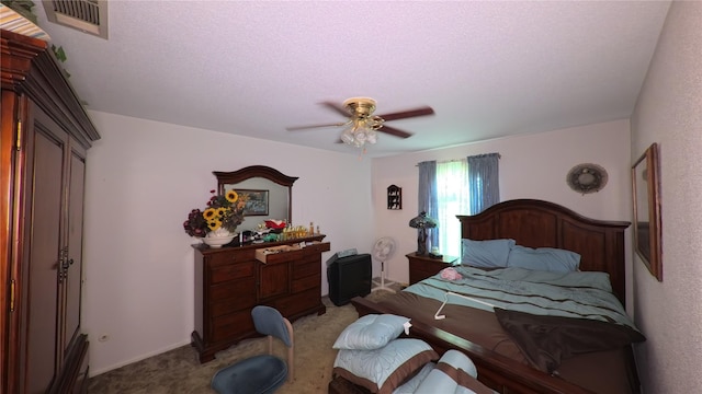 carpeted bedroom featuring ceiling fan and visible vents