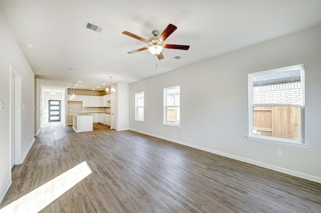 805 Apple Blossom Dr, La Marque, TX 77568 - unfurnished living room with plenty of natural light, visible vents, ceiling fan, and light wood-type flooring