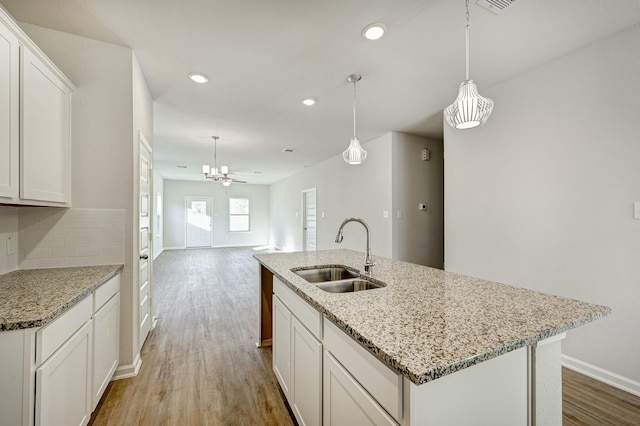 805 Apple Blossom Dr, La Marque, TX 77568 - kitchen with baseboards, light wood finished floors, recessed lighting, and a sink