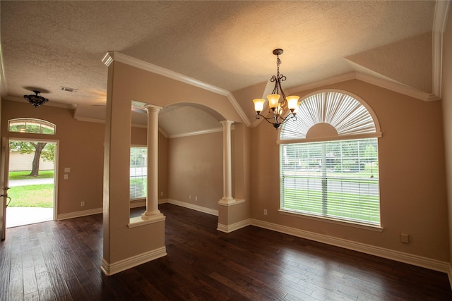 13847 Ventura Rd, Willis, TX 77318 - spare room with decorative columns, a textured ceiling, visible vents, vaulted ceiling, and dark wood-style flooring