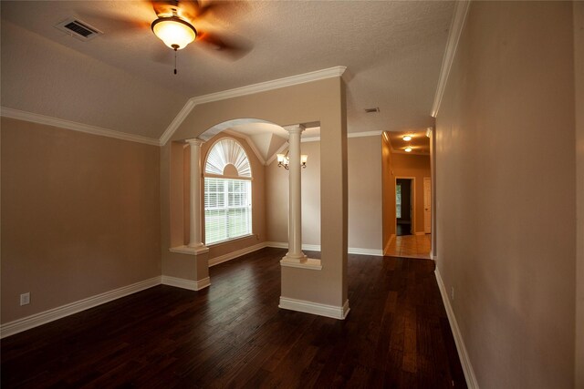 13847 Ventura Rd, Willis, TX 77318 - empty room with ornate columns, visible vents, dark wood finished floors, crown molding, and arched walkways