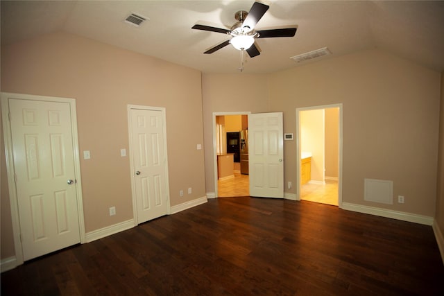 13847 Ventura Rd, Willis, TX 77318 - unfurnished bedroom featuring lofted ceiling, dark wood-style flooring, baseboards, and visible vents