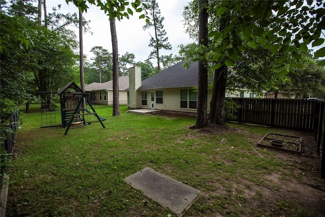 13847 Ventura Rd, Willis, TX 77318 - view of yard with a playground, a patio area, and a fenced backyard