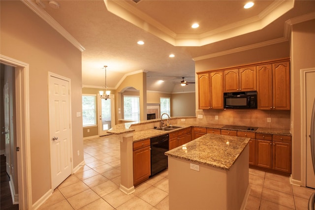 13847 Ventura Rd, Willis, TX 77318 - kitchen with a sink, a peninsula, black appliances, crown molding, and a raised ceiling