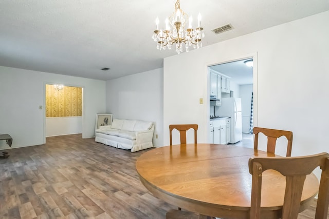 4308 Red Oak Dr, Nacogdoches, TX 75965 - dining space with a chandelier, visible vents, and wood finished floors