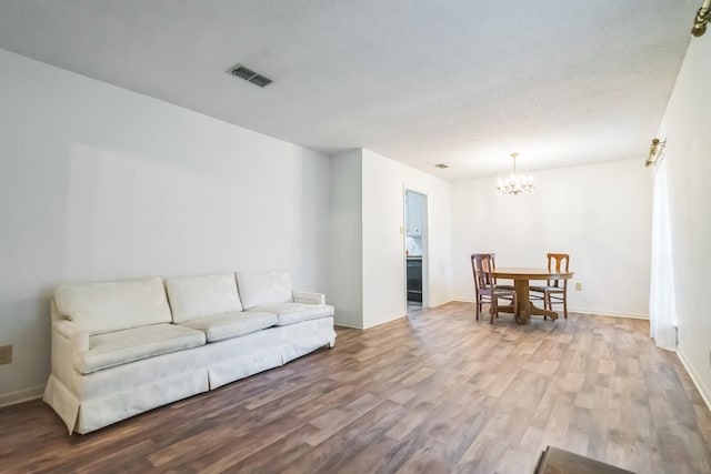 4308 Red Oak Dr, Nacogdoches, TX 75965 - living room featuring baseboards, a chandelier, wood finished floors, and visible vents