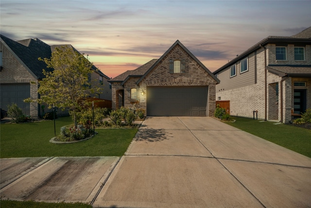 view of front of home with driveway, brick siding, and a front yard