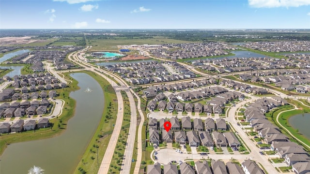 drone / aerial view with a water view and a residential view
