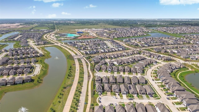 birds eye view of property featuring a water view and a residential view