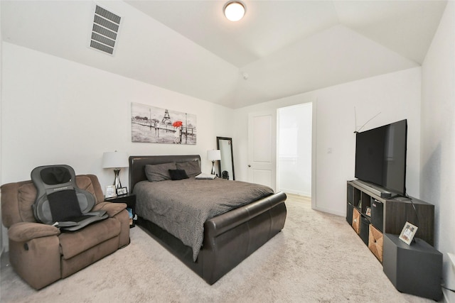 bedroom featuring vaulted ceiling, carpet floors, and visible vents
