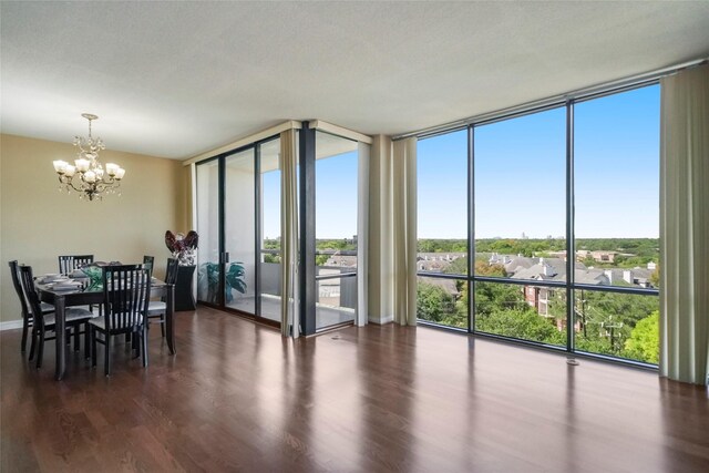 dining area featuring a wall of windows, a chandelier, and dark wood-type flooring