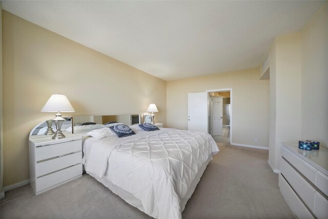 bedroom featuring light colored carpet and baseboards