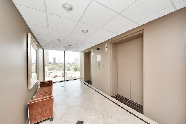 community lobby featuring a wall of windows, a paneled ceiling, and recessed lighting