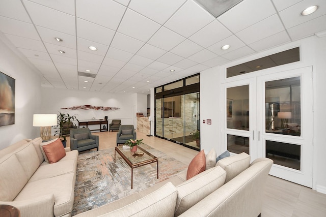 living area featuring recessed lighting and a paneled ceiling
