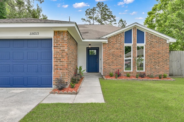 22603 Pebworth Pl, Spring, TX 77373 - view of front facade with brick siding, a garage, roof with shingles, and driveway