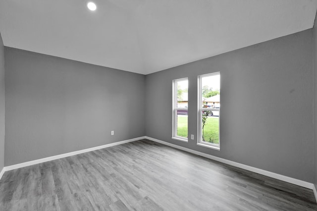22603 Pebworth Pl, Spring, TX 77373 - spare room with baseboards, wood finished floors, and vaulted ceiling