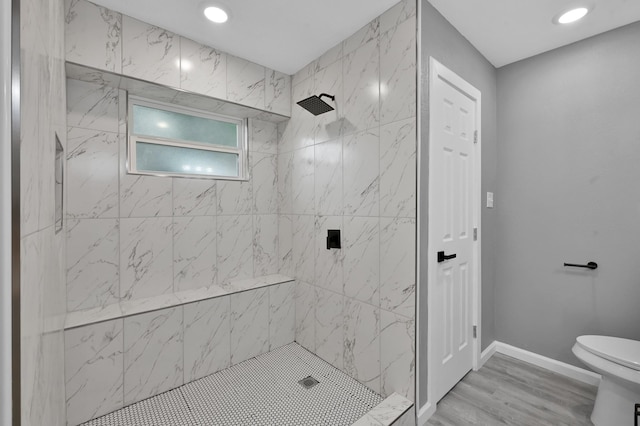 22603 Pebworth Pl, Spring, TX 77373 - bathroom featuring toilet, tiled shower, wood finished floors, baseboards, and recessed lighting
