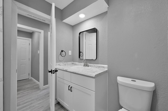 22603 Pebworth Pl, Spring, TX 77373 - half bathroom featuring toilet, wood finished floors, vanity, and baseboards