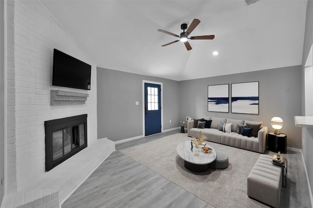 22603 Pebworth Pl, Spring, TX 77373 - living room featuring vaulted ceiling, ceiling fan, baseboards, a fireplace, and wood finished floors