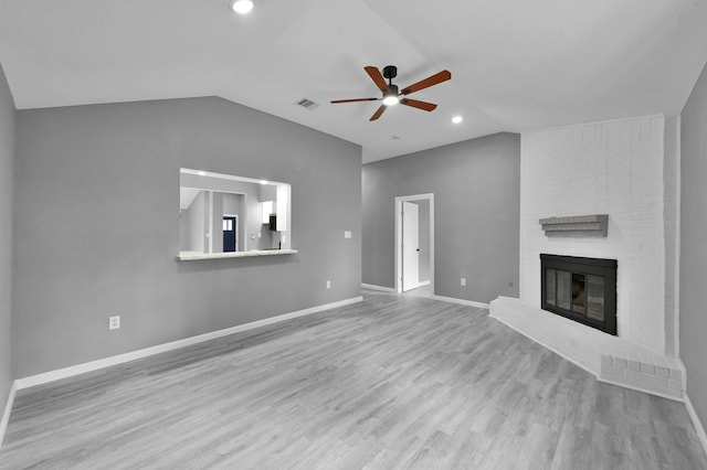 22603 Pebworth Pl, Spring, TX 77373 - unfurnished living room featuring lofted ceiling, a ceiling fan, a brick fireplace, wood finished floors, and baseboards