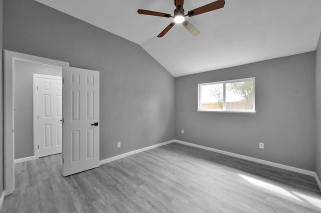 22603 Pebworth Pl, Spring, TX 77373 - unfurnished bedroom with vaulted ceiling, wood finished floors, baseboards, and a ceiling fan