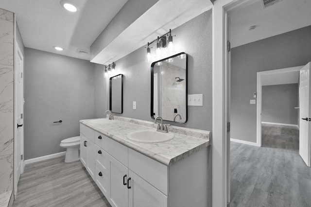 22603 Pebworth Pl, Spring, TX 77373 - full bathroom featuring wood finished floors, recessed lighting, double vanity, toilet, and a shower