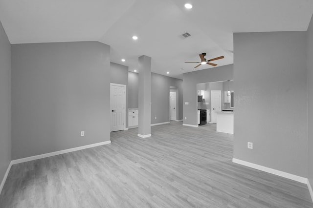 22603 Pebworth Pl, Spring, TX 77373 - unfurnished living room featuring ceiling fan, baseboards, light wood finished floors, vaulted ceiling, and recessed lighting