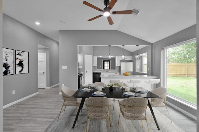 22603 Pebworth Pl, Spring, TX 77373 - dining area featuring lofted ceiling, ceiling fan, light wood finished floors, and baseboards