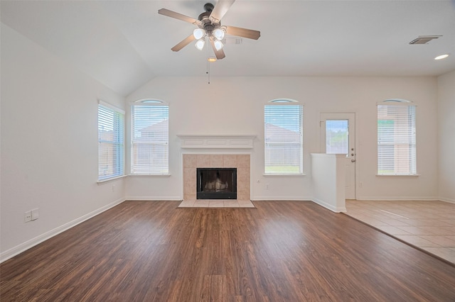 unfurnished living room with baseboards, a fireplace, ceiling fan, and wood finished floors
