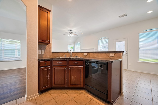 kitchen with plenty of natural light, black dishwasher, visible vents, and a sink
