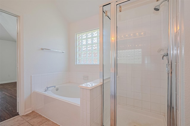 full bathroom with a stall shower, tile patterned floors, a garden tub, and baseboards