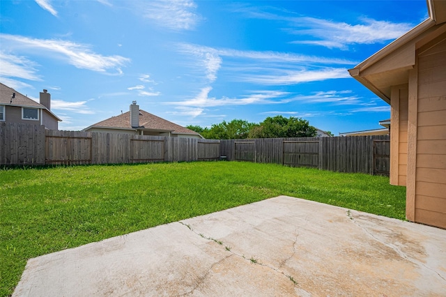 view of yard with a patio area and a fenced backyard