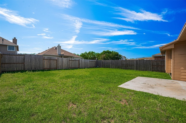 view of yard with a patio and a fenced backyard