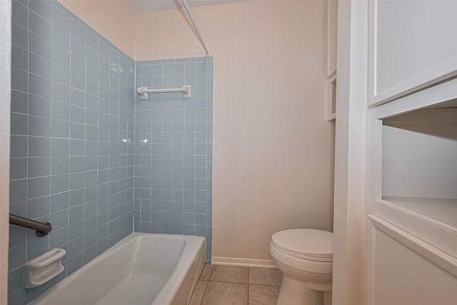 bathroom featuring toilet, baseboards, tile patterned floors, and shower / bathing tub combination