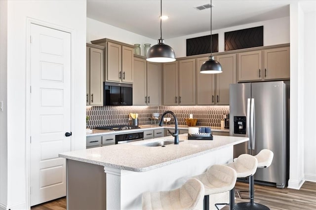 8251 Red Shiner Way, Fulshear, TX 77441 - kitchen featuring dark wood finished floors, appliances with stainless steel finishes, visible vents, and a sink