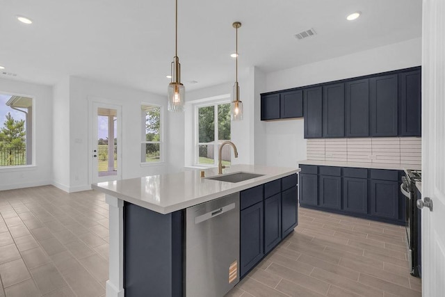 8251 Red Shiner Way, Fulshear, TX 77441 - kitchen with stainless steel appliances, light countertops, recessed lighting, decorative light fixtures, and a center island with sink
