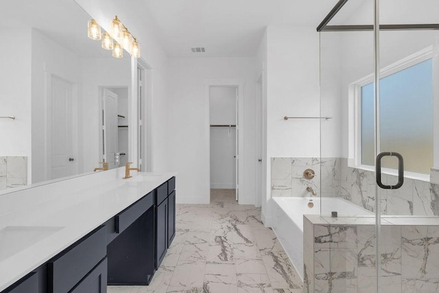8251 Red Shiner Way, Fulshear, TX 77441 - full bath featuring marble finish flooring, a garden tub, double vanity, a marble finish shower, and a spacious closet