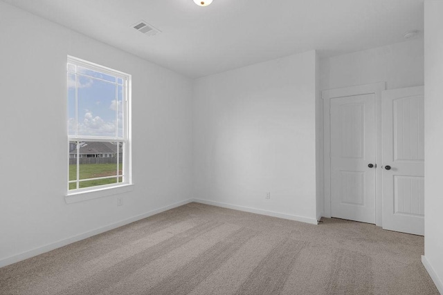 8251 Red Shiner Way, Fulshear, TX 77441 - empty room with carpet flooring, healthy amount of natural light, and a smoke detector