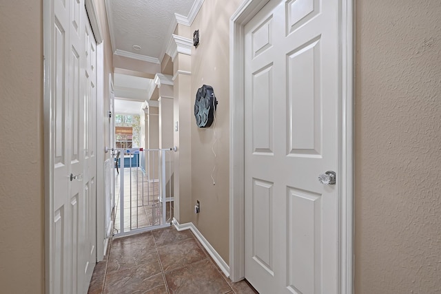 7551 Basswood Forest Ct, Houston, TX 77095 - corridor with crown molding, baseboards, dark stone finish floors, a textured ceiling, and a textured wall