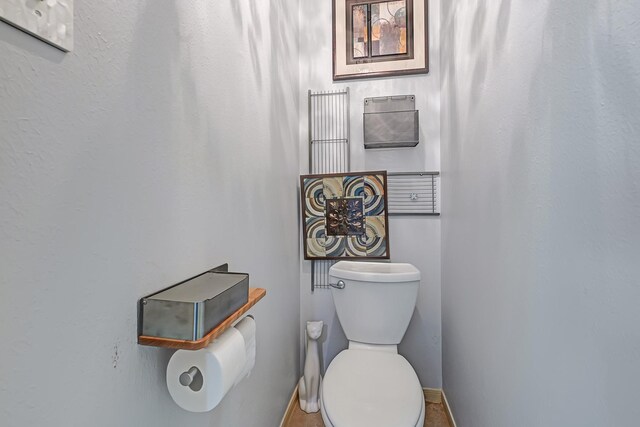 7551 Basswood Forest Ct, Houston, TX 77095 - bathroom featuring baseboards and toilet
