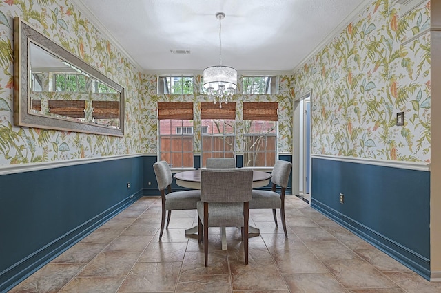 7551 Basswood Forest Ct, Houston, TX 77095 - dining room with wallpapered walls, ornamental molding, a wainscoted wall, a chandelier, and baseboards