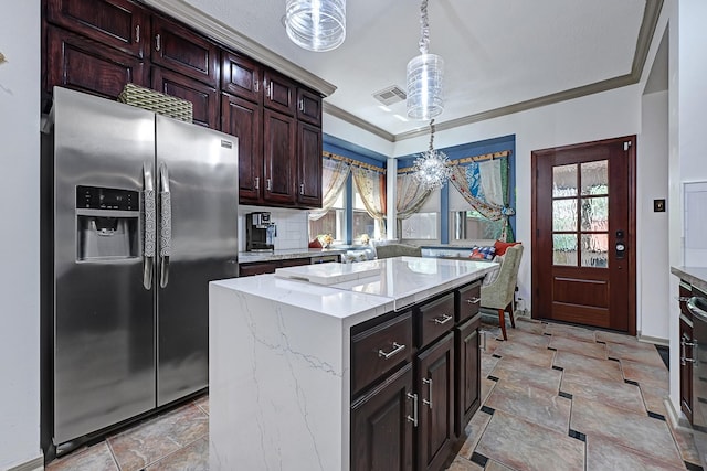 7551 Basswood Forest Ct, Houston, TX 77095 - kitchen featuring stainless steel refrigerator with ice dispenser, pendant lighting, stone finish flooring, crown molding, and light stone countertops