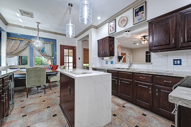 7551 Basswood Forest Ct, Houston, TX 77095 - kitchen featuring a sink, ornamental molding, decorative backsplash, a kitchen island, and hanging light fixtures