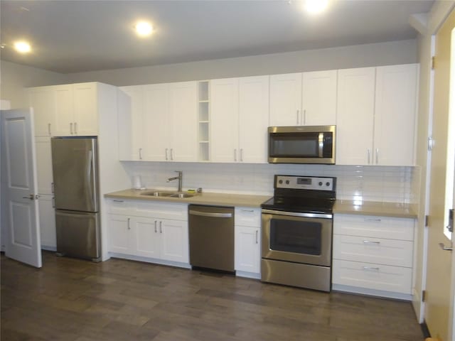 2401 Crawford Unit 105, Houston, TX 77004 - kitchen featuring stainless steel appliances, a sink, open shelves, white cabinets, and backsplash