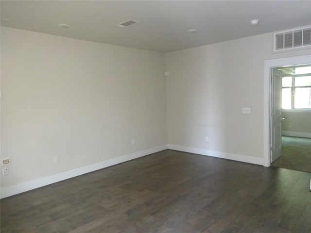 2401 Crawford Unit 105, Houston, TX 77004 - spare room featuring dark wood-style floors and baseboards