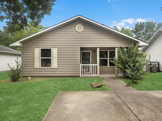 view of front facade with a patio and a front lawn