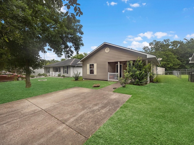 single story home featuring a front yard, covered porch, and fence