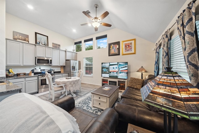 257 N Lynx Trl, Montgomery, TX 77316 - living room with lofted ceiling, a wealth of natural light, light wood-style flooring, and a ceiling fan